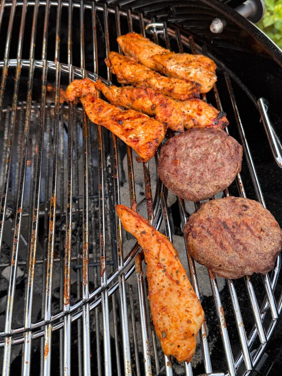 Marinated chicken strips on a BBQ