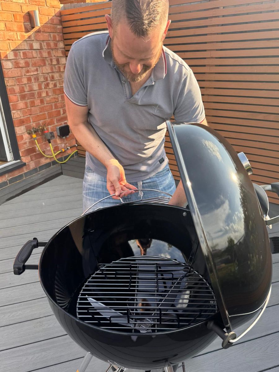 Dan setting up his Weber kettle BBQ on the composite deck he built