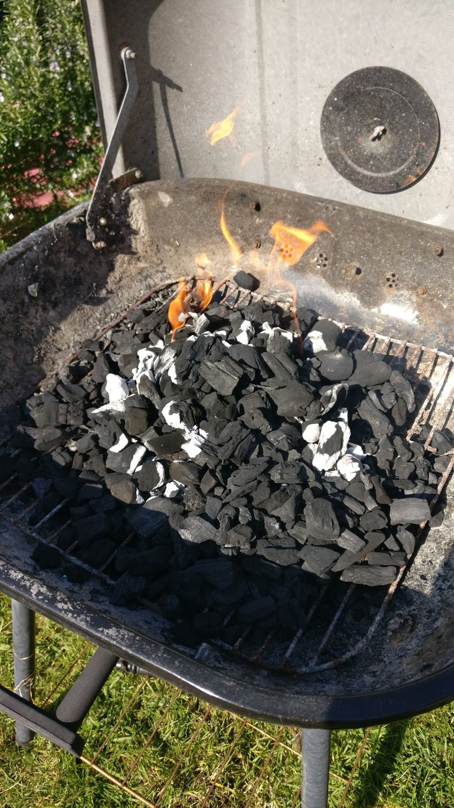 Lumpwood charcoal catching light on an old charcoal BBQ