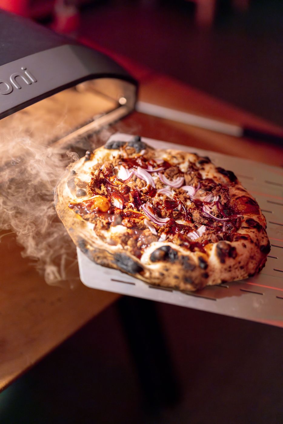 Launching a pizza from a peel into a compact oven