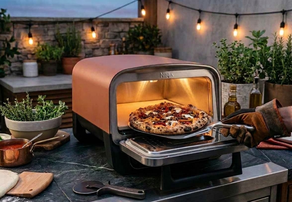 Illustration of a Ninja Woodfire electric pizza oven on an outdoor kitchen worktop