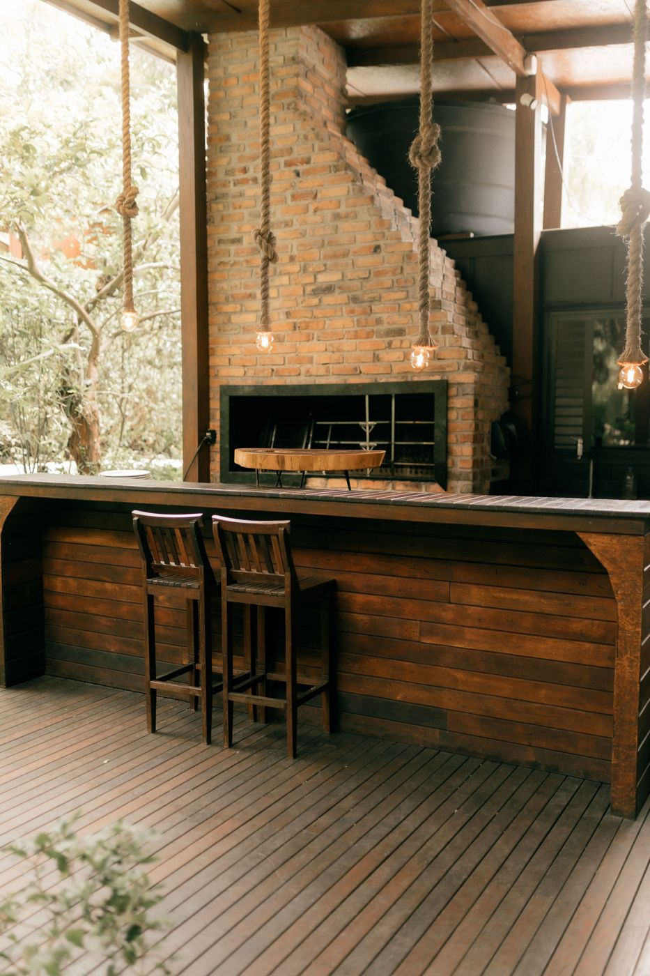 Brick-built BBQ island with a wooden bar top