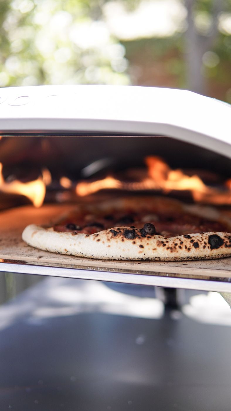 Close-up of a blistered pizza crust in an oven