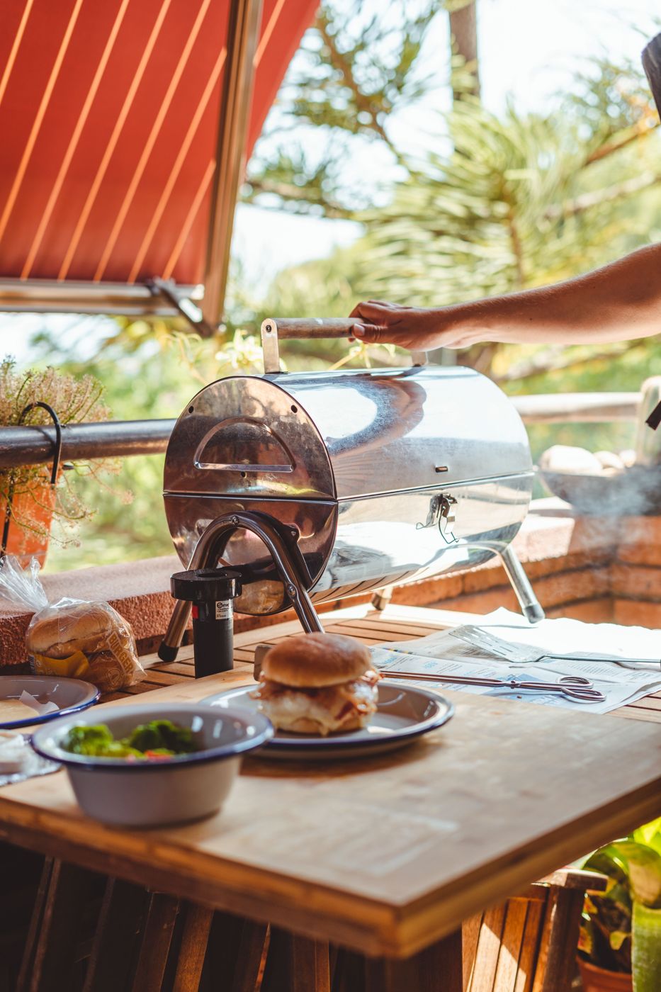 Burger cooking on a small portable grill