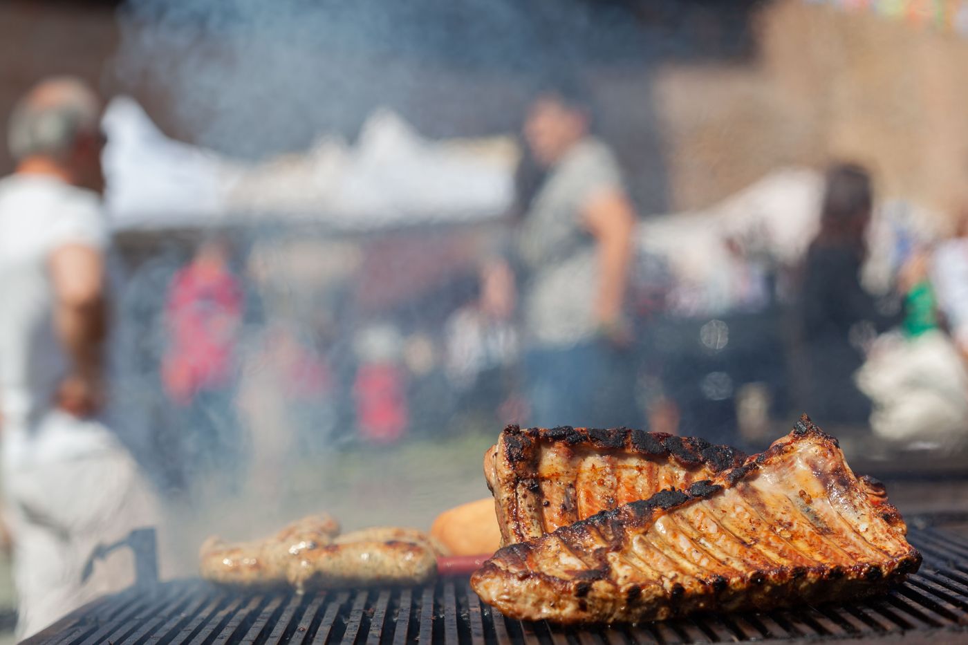 Racks of ribs cooking on a grill
